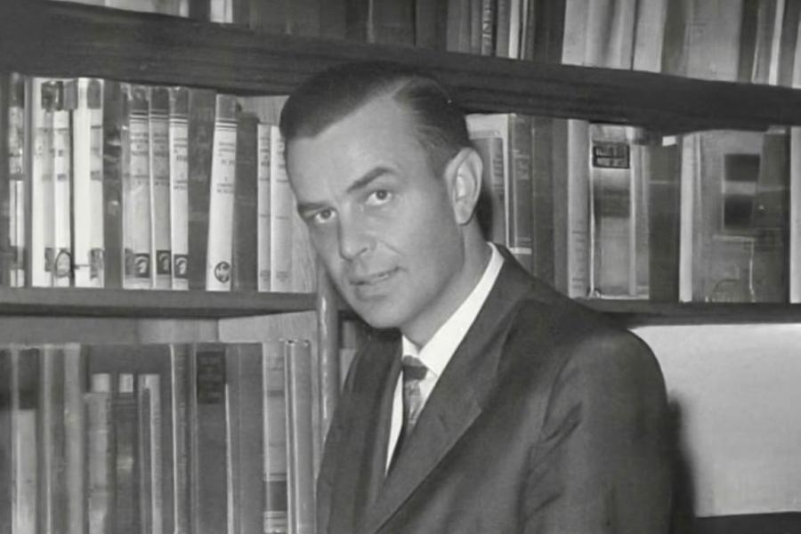 Calvin B. Hanson in library looking at book