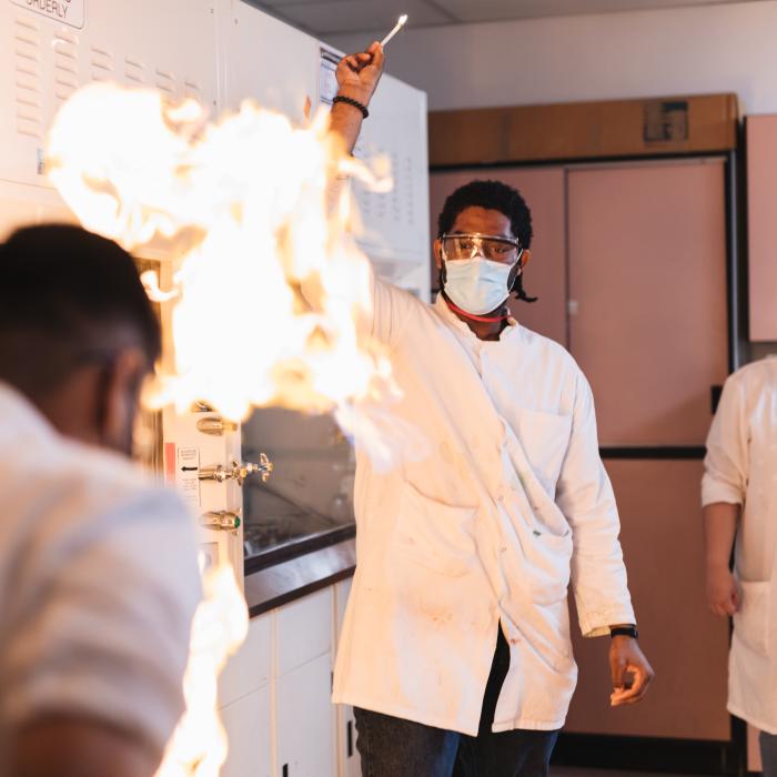 student doing experiment with fire