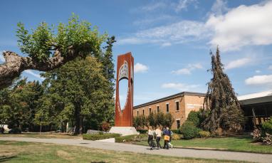 students walking outside library and bell tower