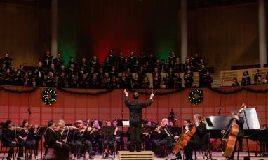 conductor leading orchestra and choir