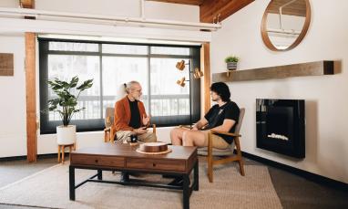 two people sitting in room talking