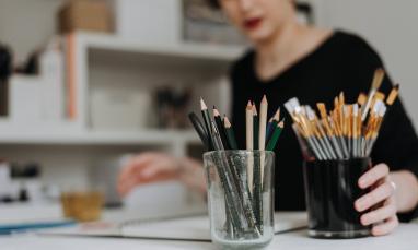 girl at table with art supplies