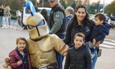 kids and alumni posing with Sparty
