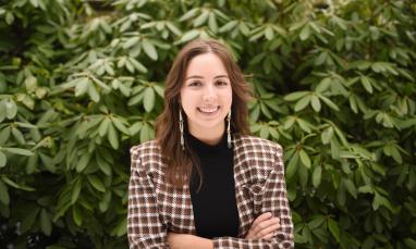 Madison Stenner standing in front of green plants