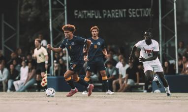 student athlete playing soccer on field