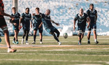 student athletes playing rugby on field