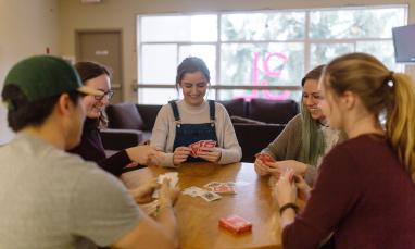 students playing cards at a table