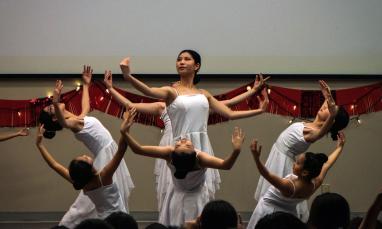 Group of women dancing in white dresses