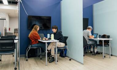 students working in library study rooms