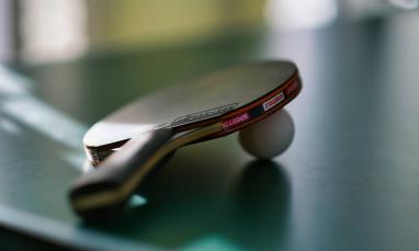 ping pong racket and ball on table