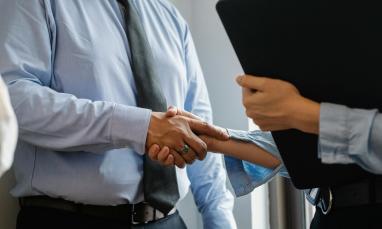 people in professional attire shaking hands