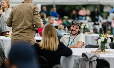man sitting at table across from woman