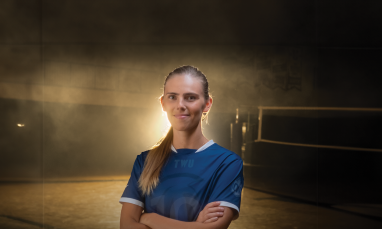 Emma Gamache standing in gym in front of light