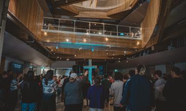 Students worshipping at Saturday Night Alive