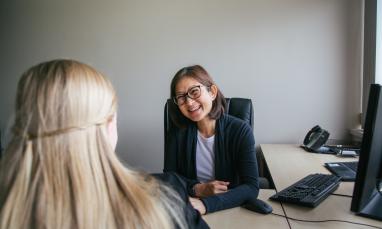 Woman sitting at a desk for an interview