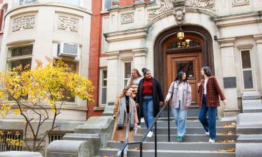 Students walking down the stairway of a building entrance