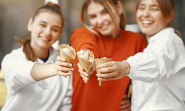 a group of girls holding icecream cones