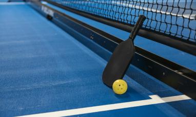 A pickleball paddle and net.