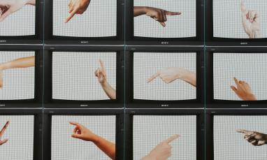 Multiple screens displaying different hands pointing in various directions.