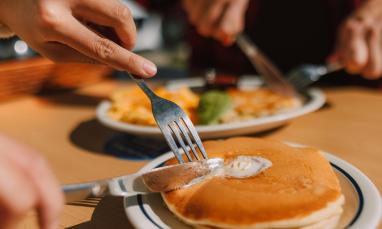 stock photo of people cutting pancakes