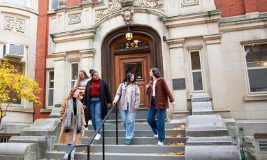 Students walking down the stairway of a building entrance