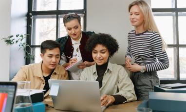 Group of people all staring at a computer