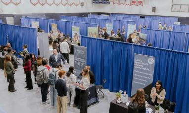 Career Fair setup in Gym with people at booths talking