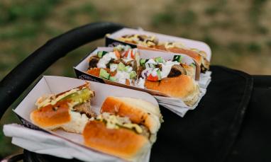 BBQ food served in trays outdoors.
