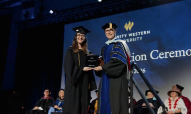 Jenessa Butler receiving a Valedictorian plaque from Rob Rhea