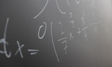 Mathematical formulas written on a classroom chalkboard.