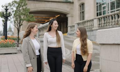 Three Laurentian Leadership Centre students walking and talking outside in downtown Ottawa.