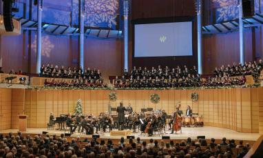 TWU choir and orchestra performing a holiday concert in a packed concert hall.