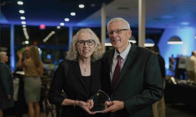 Darwin and Darlis Anderson holding the 2026 Live Faithfully Award at TWU’s Alumni Awards Dinner.