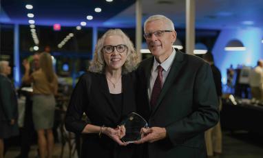 Darwin and Darlis Anderson holding the 2026 Live Faithfully Award at TWU’s Alumni Awards Dinner.