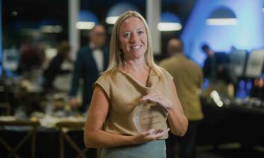 Sara Kraushar smiling and holding her 2026 Think Truthfully Award at TWU’s Alumni Awards Dinner.