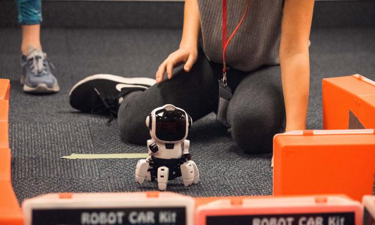 people sitting on floor with robot