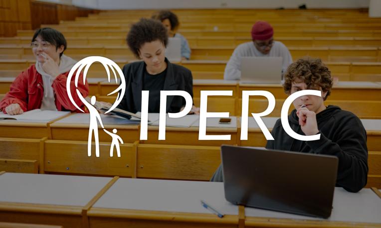 IPERC logo in front of people in classroom