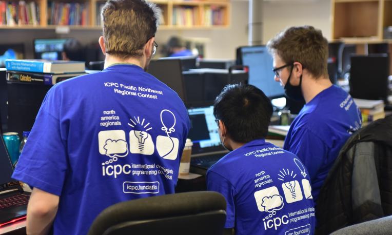 computer science students working together facing away from the camera