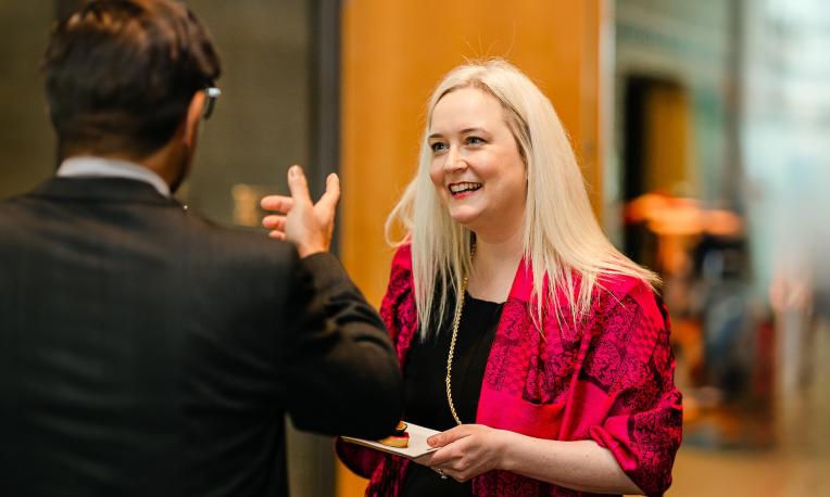 Rochelle Salazar talking with someone at a reception