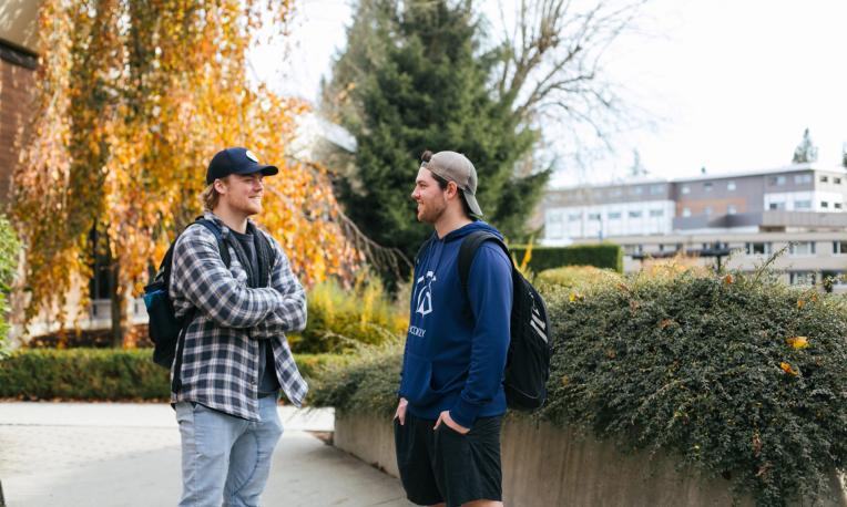 two students talking to each other on campus