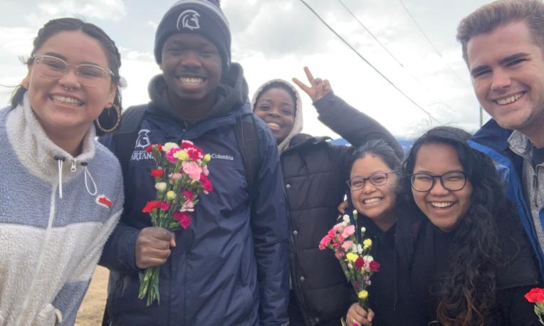 global outreach student group holding roses