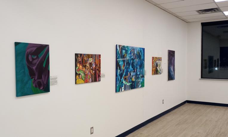 Paintings mounted on a wall.