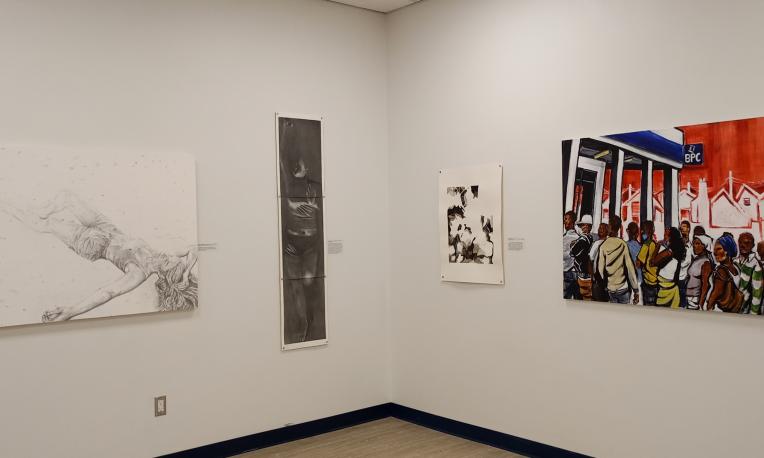 Paintings mounted on a wall.
