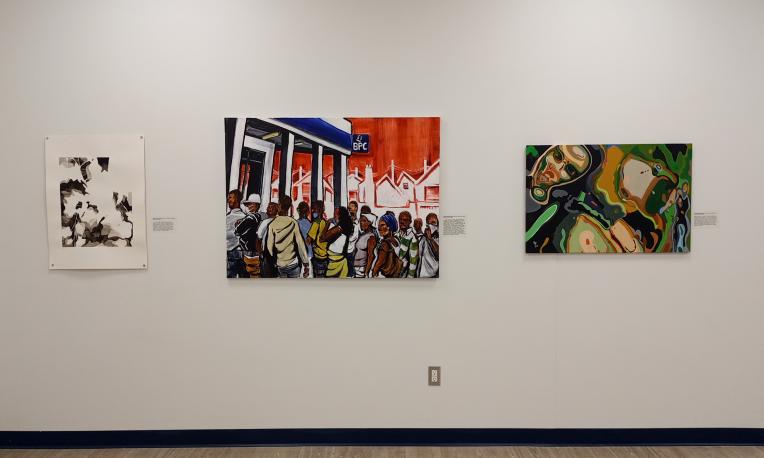 Paintings mounted on a wall.