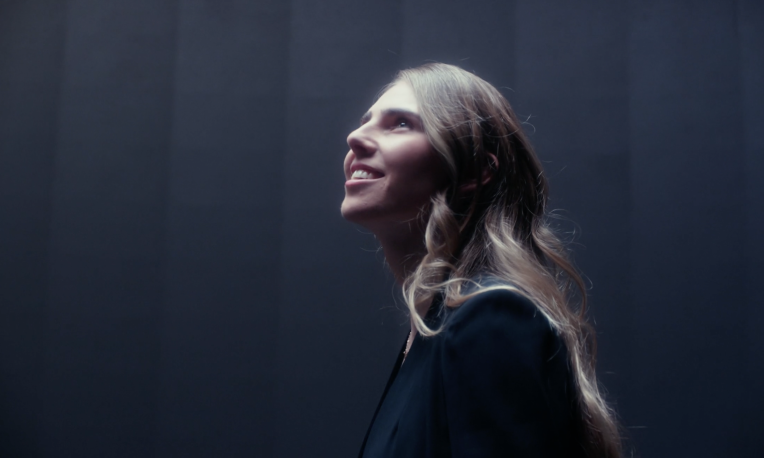 Emma Gamache standing in front of screen