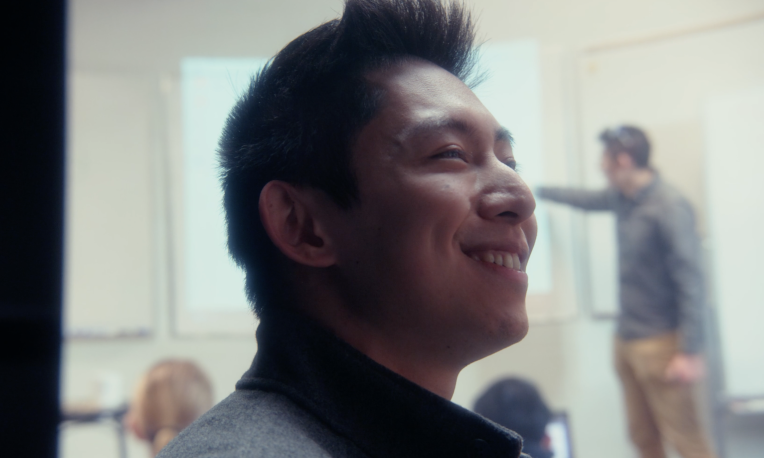 Sean Hui standing in front of screen