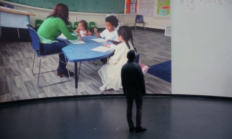 Sean Hui standing in front of screen