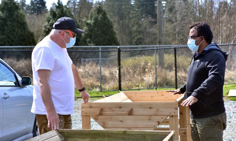 Two people working on a wood project.