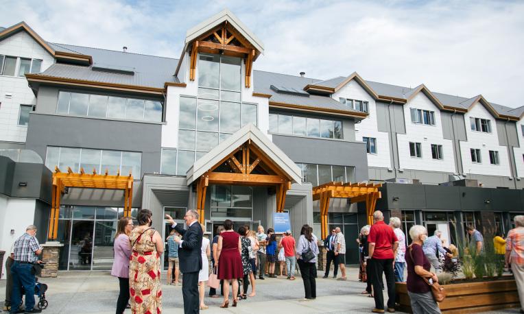 People gather in front of the DeVries Centre