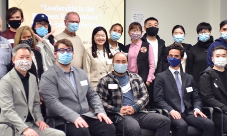 TWU staff sitting together posing for a photo with masks on